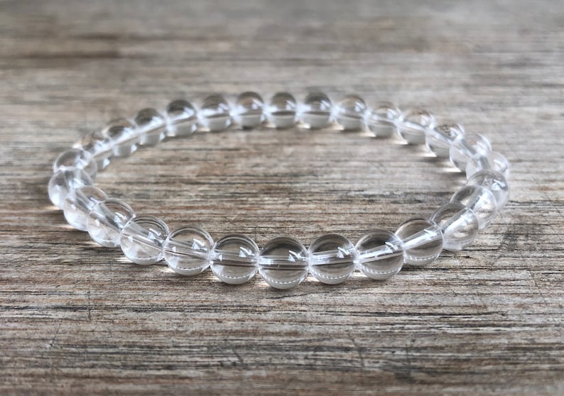 May include: A clear quartz crystal bracelet with round beads.