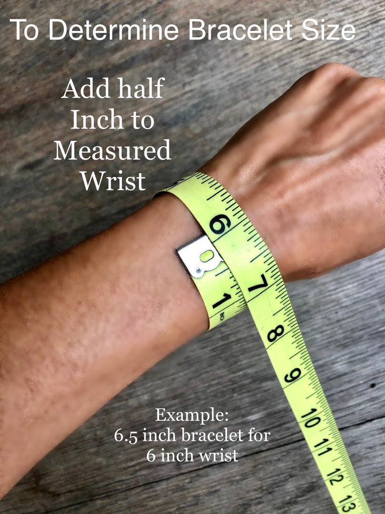 May include: A yellow measuring tape wrapped around a wrist to demonstrate how to determine bracelet size. The text reads "To Determine Bracelet Size", "Add half Inch to Measured Wrist", and "Example: 6.5 inch bracelet for 6 inch wrist".