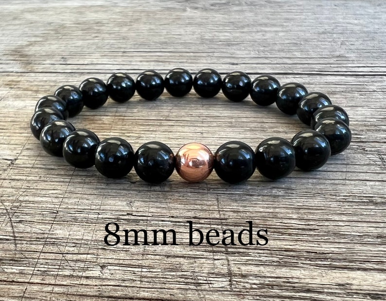 May include: Black beaded bracelet with a single rose gold bead. 8mm beads.
