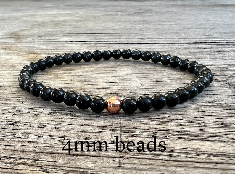 May include: Black beaded bracelet with a single rose gold bead. 4mm beads.