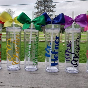 May include: Six clear plastic tumblers with straws and colorful bows. Each tumbler is personalized with a teacher's name, including "Miss Tammy", "Mrs. Oberlin", "Mrs. Burchholder", "Mr. Hefner", "Mrs. Meurer", and "Mrs. Quigley".