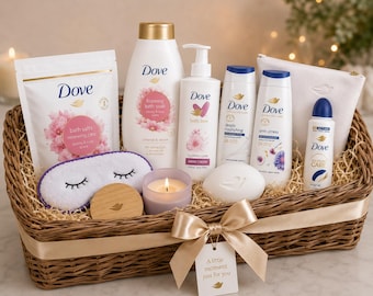 May include: A wicker gift basket containing Dove brand bath products including bath salts, foaming bath soak, hand cream, body wash, deodorant, a bar of soap, a white sleep mask, a wooden disc, a lit candle, and a white pouch with a ribbon and tag.