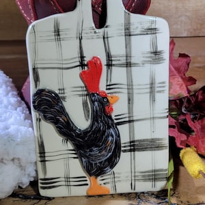 May include: A set of three ceramic mugs with a speckled, matte finish. The mugs are in shades of cream, light gray, and dark gray. Each mug has a simple, modern design and a rounded handle. Perfect for coffee or tea.