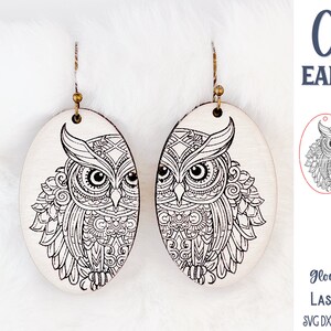 May include: Oval-shaped wooden earrings featuring a detailed black line art owl illustration. The earrings hang from bronze-colored metal hooks. The image includes text reading Owl EARRINGS, Glowforge Tested LASER CUT FILE, and SVG DXF PNG JPG EPS PDF AI.