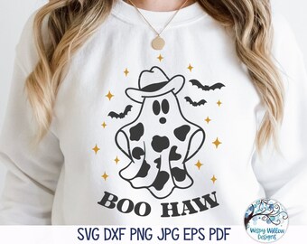 May include: A white sweatshirt with a black and white ghost wearing a cowboy hat and the text "BOO HAW" printed on it. The ghost has a cow print pattern. The background has gold stars and black bats.