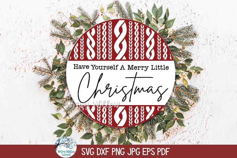May include: A circular sign featuring a red and white cable knit sweater pattern on the top and bottom sections, with a white center band displaying the black text Have Yourself A Merry Little Christmas in a mix of serif and script fonts.