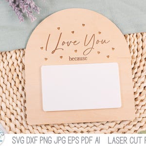 May include: An arched light-colored wooden sign featuring the engraved text I Love You because and small heart cutouts. A blank white rectangular insert is positioned in the center of the wooden plaque, providing a space for custom messages.