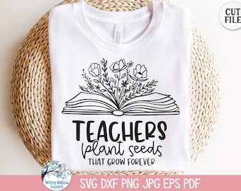 May include: A white t-shirt featuring a black line art graphic of an open book with flowers emerging from the pages. Below the illustration, the text reads "TEACHERS plant seeds THAT GROW FOREVER" in a combination of bold and script fonts.