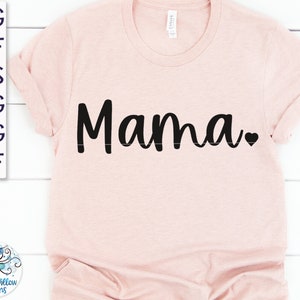 May include: A pink t-shirt with the word "Mama" in black cursive lettering and a small black heart.