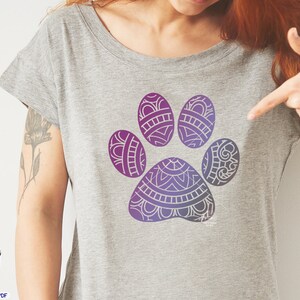 May include: A gray t-shirt with a purple and blue mandala paw print design.