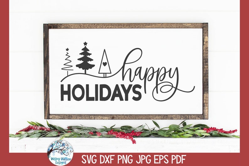 Pode incluir: Uma placa branca com moldura de madeira marrom, apresentando o texto "happy holidays" em escrita cursiva preta. Tr&ecirc;s &aacute;rvores de Natal estilizadas pretas s&atilde;o representadas acima do texto, com um pequeno cora&ccedil;&atilde;o na &aacute;rvore do centro.