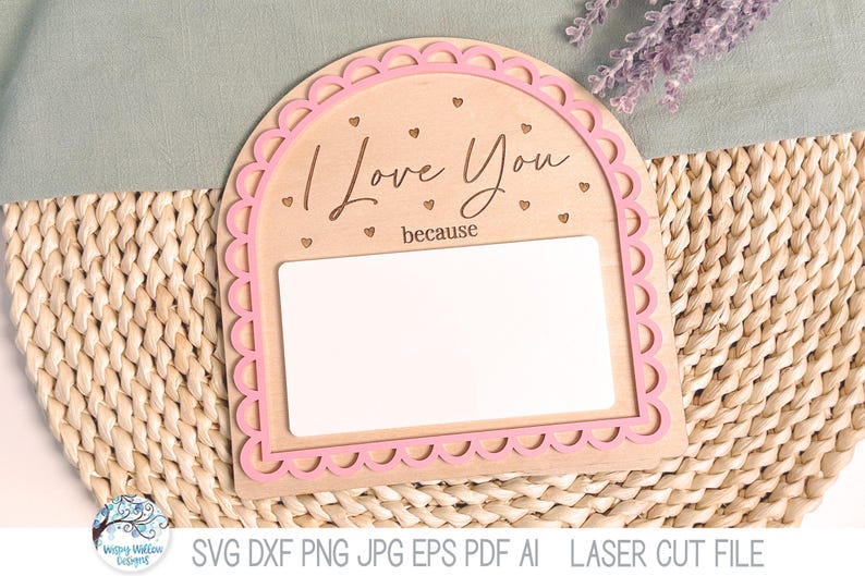 May include: An arched wooden sign with a pink scalloped border, featuring the engraved text "I Love You because" and small heart icons. The sign includes a large, blank white rectangular space for writing messages, designed as a laser cut file.