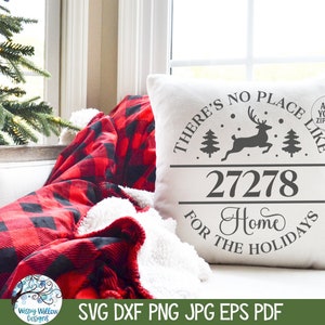 May include: A white square throw pillow featuring a dark gray graphic of a leaping reindeer, two pine trees, and the text "THERE'S NO PLACE LIKE 27278 HOME FOR THE HOLIDAYS" with a small circular badge that reads "ADD YOUR ZIPCODE".