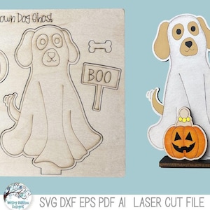 May include: A wooden laser cut Halloween dog ghost with a pumpkin and a sign that says "BOO". The design includes a bone and a pumpkin. The text "Build your own Dog Ghost" is at the top.
