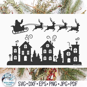May include: Black silhouette of Santa Claus flying in a sleigh pulled by reindeer over a town with houses and trees. The text "Wispy Willow Designs" is in the bottom right corner.