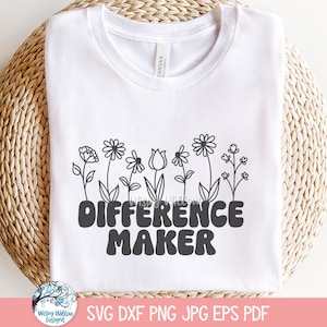 May include: A white short-sleeved t-shirt featuring a black line-art illustration of various flowers across the top. Below the floral design, the text "DIFFERENCE MAKER" is printed in a bold, rounded, dark gray sans-serif font on the chest area.