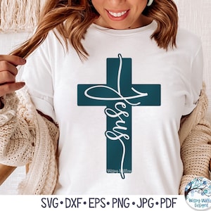 May include: A white t-shirt with a teal blue cross and the word "Jesus" written in a cursive font inside the cross. The text "Wispy Willow Designs" is written below the cross.
