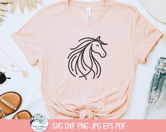 May include: A light pink t-shirt featuring a black line drawing of a horse's head and flowing mane. The shirt is made of soft material. The bottom right corner displays the text "SVG DXF PNG JPG EPS PDF".