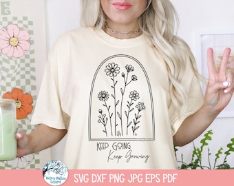 Pode incluir: Uma camiseta cor de creme com um contorno preto de um arco floral e o texto "Keep Going Keep Growing".