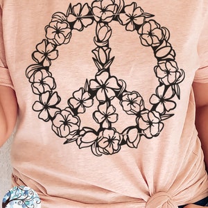 May include: A pink t-shirt with a black peace sign design made of flowers. The text "PEACE SIGN SVG FILE" is at the bottom of the image.