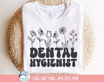 May include: A white t-shirt with a black graphic design of flowers and the text "Dental Hygienist" in a retro font.