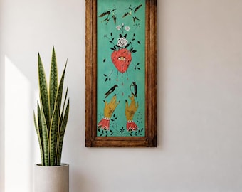 May include: A vertical rectangular painting in a dark brown wooden frame featuring a teal background with a central red heart containing an eye, surrounded by white flowers, black birds, and two yellow hands with red cuffs at the bottom.