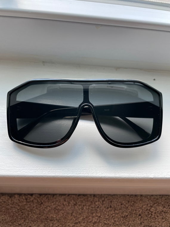 Large shield style black sunglasses