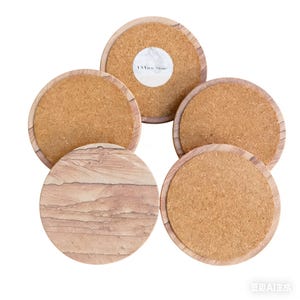 May include: A set of five round coasters featuring a natural sandstone top surface with layered tan and brown patterns. Each coaster has a light-colored wooden rim and a cork backing. One coaster displays a white circular label reading YXView Stone.