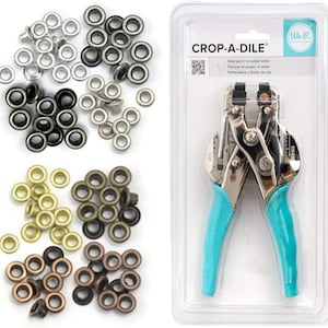 May include: A silver eyelet setter tool with blue handles, packaged in a clear plastic container. The tool is labeled "Crop-A-Dile" and is used to punch holes and set eyelets. The image also shows a variety of eyelets in different colors and sizes.