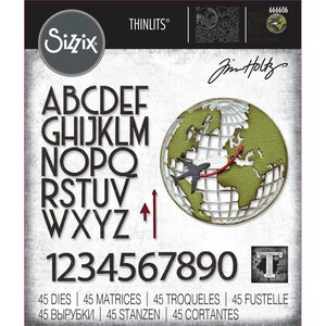 May include: Sizzix Thinlits die set featuring the alphabet, numbers, and a globe design with a plane. The set includes 45 dies for various crafting projects. The letters and numbers are in a bold, sans-serif font. The globe has a green and white color scheme.