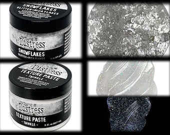 May include: Two jars of Distress brand craft supplies. One jar is labeled "Snowflakes Glitter + Mica Flakes" and the other is "Texture Paste Twinkle". The image also shows close-ups of the glitter and paste.