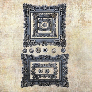 May include: Ornate, dark gray decorative frames and hardware. The image features several nested rectangular frames with intricate floral and scrollwork designs. Various decorative screws and studs are also included.