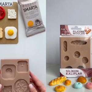 May include: A collection of silicone molds for crafting miniature food items. The set includes a tan mold with cavities for bread shapes, alongside finished clay pieces like a tomato slice, cheese, toast, and egg. Packaging features the text SMARTA.