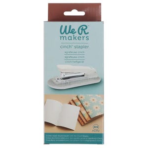 May include: A white and clear cinch stapler with the text "We R Makers" and "cinch stapler" on the packaging. The box also shows examples of bound books. The box is white, brown, and teal.