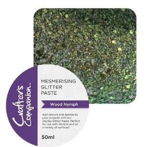 May include: A 50ml jar of green glitter paste labelled "Mesmerising Glitter Paste" and "Wood Nymph". The jar is round with a purple label and white text. The glitter paste is chunky and has a green and gold colour.