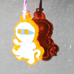 the orange acrylic phone charm in sunlight bright enough the whole image looks white except for a band around the eye holes. The light getting through the transparent parts of the charm show up bright orange in the shadow.