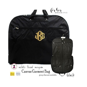 May include: Black canvas garment bag with a gold monogram and a zippered pocket. The bag is open to show the interior with multiple pockets. The text "for her MONOGRAM STYLES" is in the top right corner. The text "metallic thread monogram Canvas Garment Bag group discount available black" is at the bottom of the image.