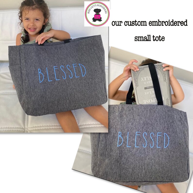 May include: Gray tote bag with the word "BLESSED" embroidered in blue. The tote bag is shown in two different photos. In the first photo, a young girl is holding the tote bag. In the second photo, the tote bag is shown with a book inside.