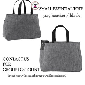 May include: Gray heather tote bag with black handles. The tote bag has a small pocket on the side. The text "SMALL ESSENTIAL TOTE gray heather/black" is displayed above the image.