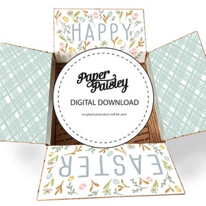 May include: An open cardboard box with floral and pastel designs. The top flaps read "HAPPY" and "EASTER" with floral accents. The interior features a circular logo that says "Paper Paisley DIGITAL DOWNLOAD". The side panels have a light blue plaid pattern.