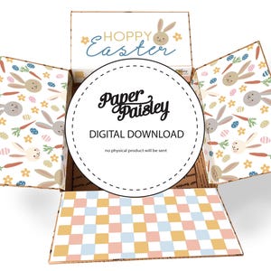 May include: An open cardboard box with an Easter theme. The box exterior features a pattern of bunnies, carrots, and eggs. The top flap reads "Hoppy Easter." The interior base has a pastel checkered pattern. A circular label reads "Paper Paisley DIGITAL DOWNLOAD."