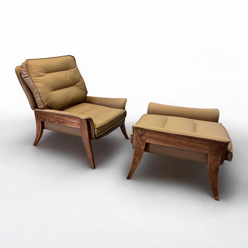 May include: A brown leather armchair with a matching ottoman. Both pieces have a tufted design and wooden legs.