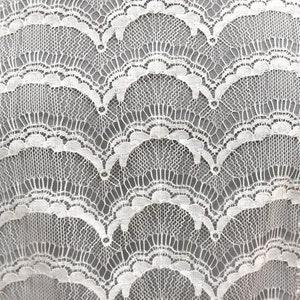 May include: White lace fabric with a scalloped pattern.