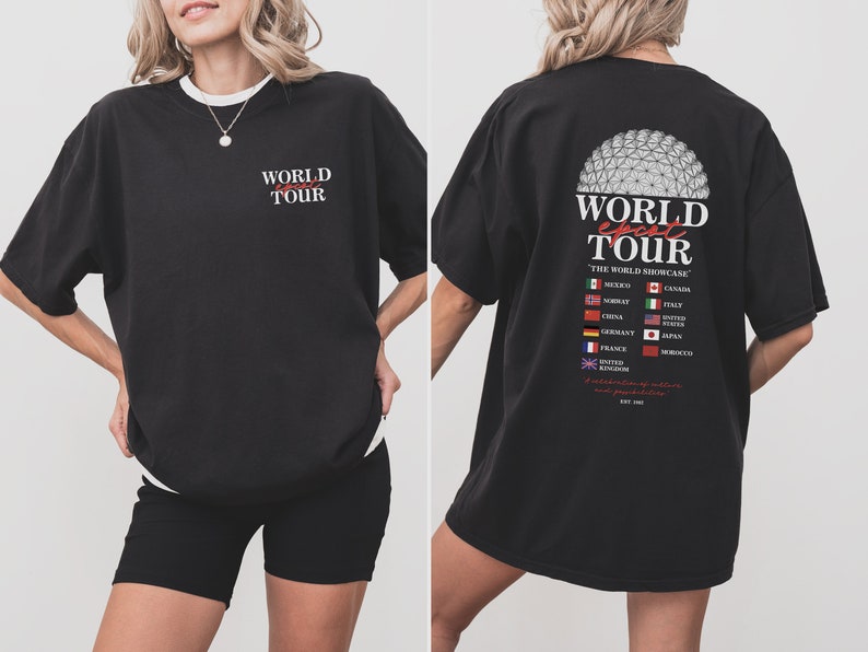 May include: Black oversized t-shirt with a graphic print of a globe and the text "WORLD epcot TOUR THE WORLD SHOWCASE" with flags representing different countries. The back of the shirt features a graphic of the Epcot Spaceship Earth.