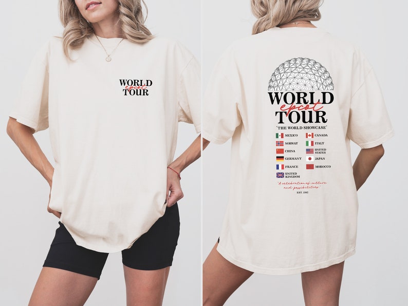 May include: A white t-shirt with a graphic print of a globe and the text "WORLD EPCOT TOUR" on the back. The text "THE WORLD SHOWCASE" is printed below the globe. The globe is surrounded by flags representing different countries, including Mexico, Canada, Norway, Italy, China, United States, Germany, Japan, France, Morocco, and the United Kingdom. The text "A celebration of culture and pavilions" is printed below the flags. The text "EST. 1982" is printed below the celebration text.