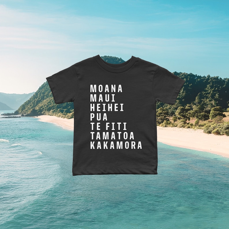 May include: Black t-shirt with white text that reads "Moana Maui Hei Hei Pua Te Fiti Tamatoa Kakamora".