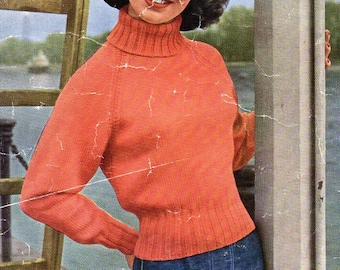 May include: A woman wearing a red turtleneck sweater and blue jeans. The sweater is a knit pattern and the woman is standing next to a white pole. The pole has the text "Sirdar No. 1656 Double Knitting Wool Four Sizes Bust 32/34/36/38 inches 6p" printed on it.