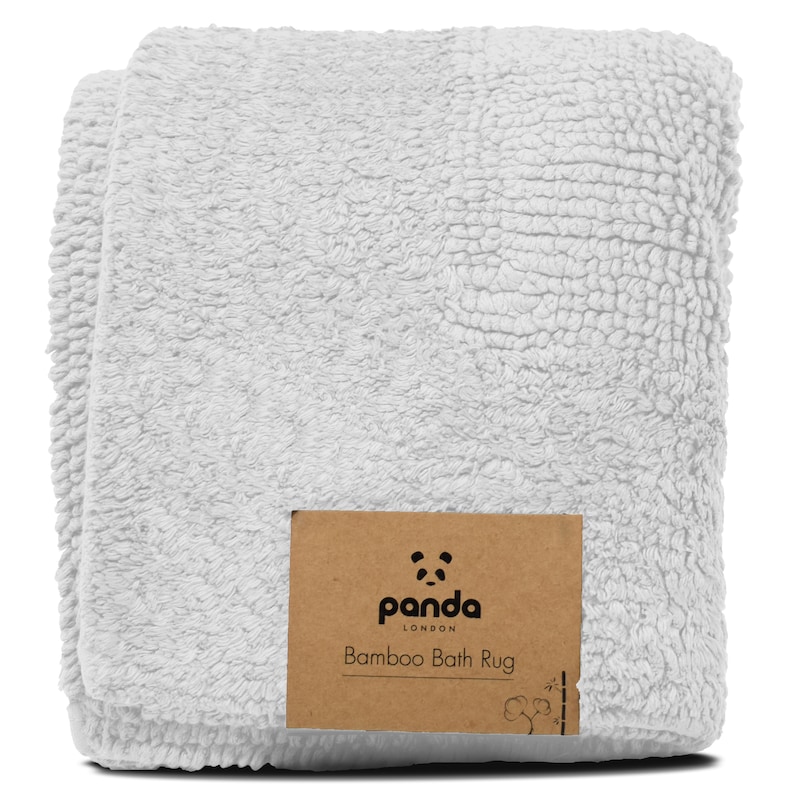 May include: White bamboo bath rug with a brown label that says "panda LONDON Bamboo Bath Rug".