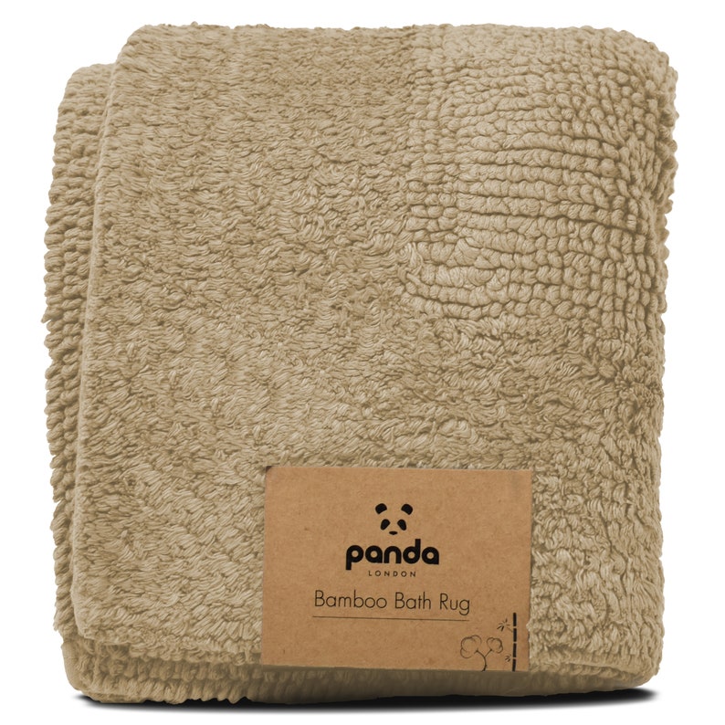 May include: A beige bamboo bath rug with a brown label that says "panda LONDON Bamboo Bath Rug".