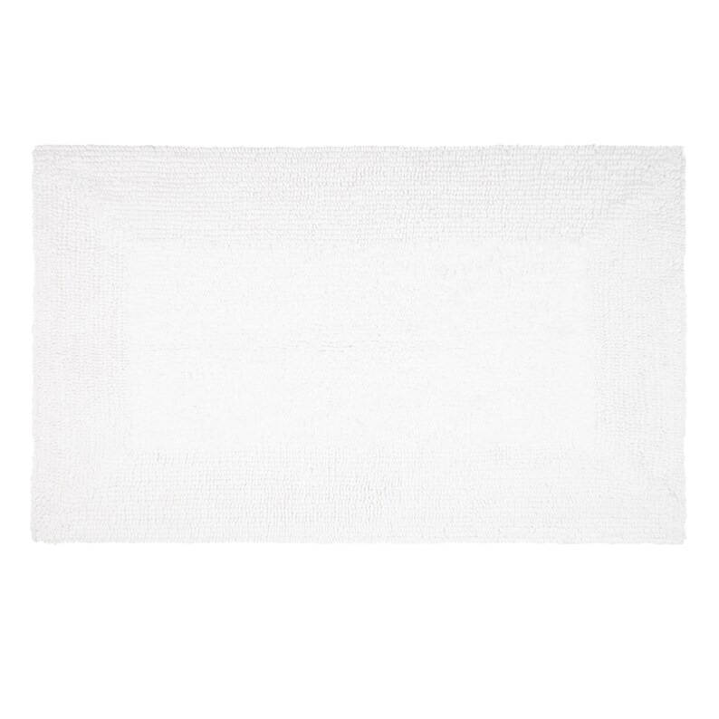 May include: White bath mat made of soft, absorbent material. The mat is rectangular and has a textured surface.
